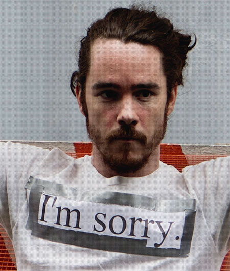 student with letters sorry on t-shirt