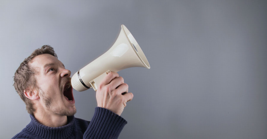 man shouting in megaphone