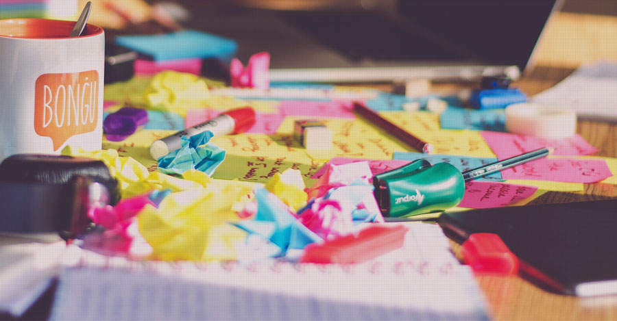 messy desk with sticky notes