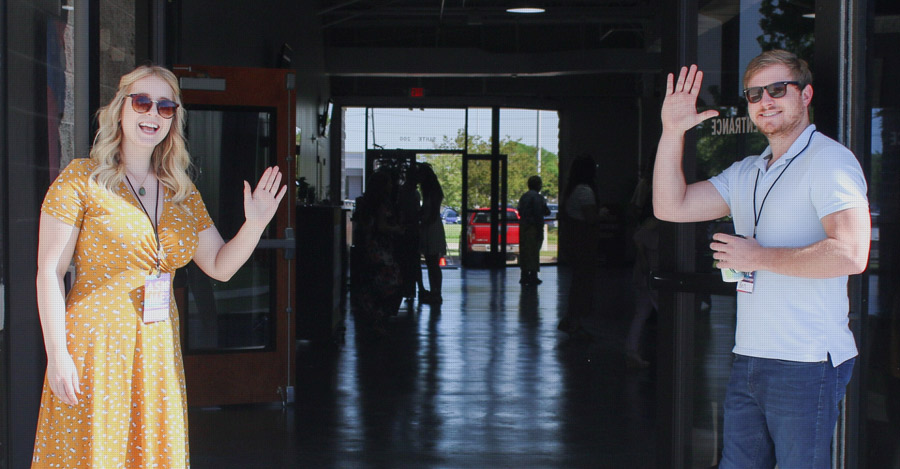 people welcoming others at conference