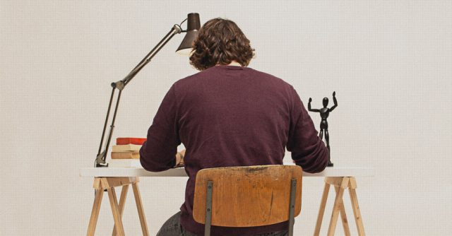 Scientist writing at desk.