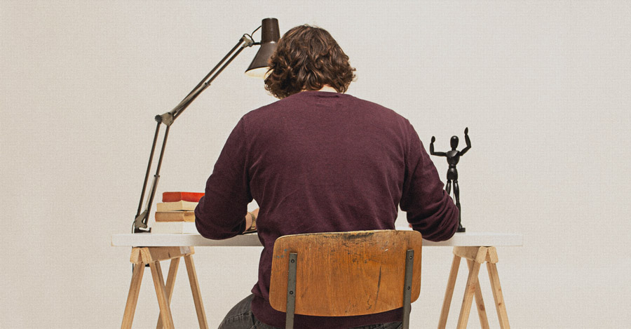 Scientist writing at desk.