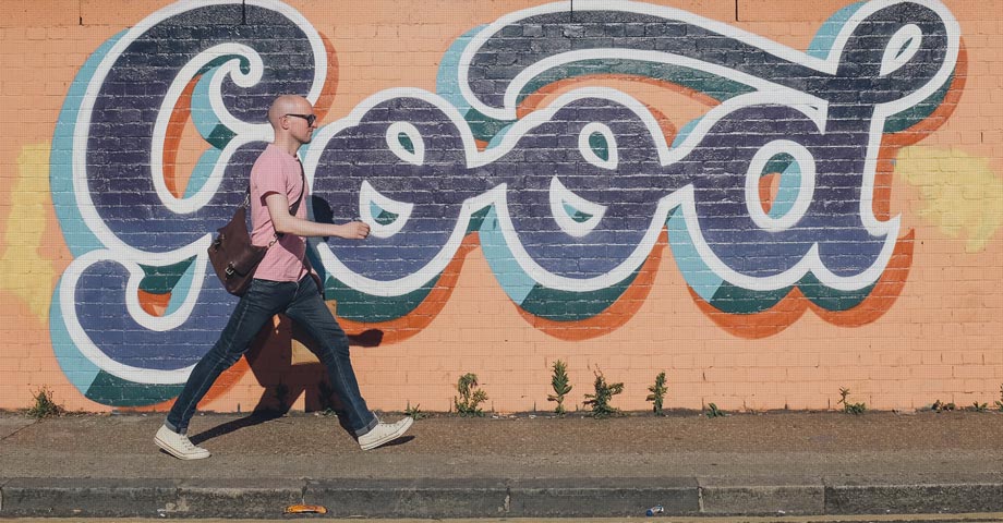 person in front of slogan 'good'